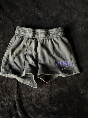 Kids Nike Black Shorts with Purple Nike Script and White Swoosh